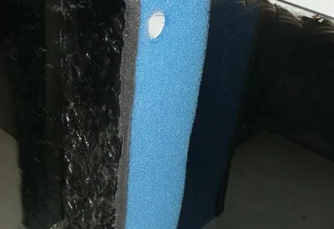 A foam filter mat in the corner of an aquarium
